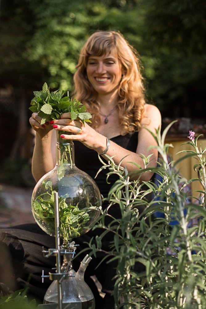 herbalist alexandra hudson making medicine in lab glass