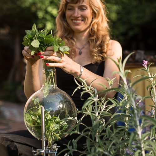 herbalist alexandra hudson making medicine in lab glass